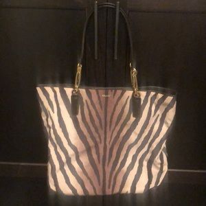 COPY - Brown and tan coach purse and matching wallet .